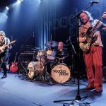 Image shows Voodoo Room band performing with two guitarists and a drummer