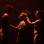 Image shows three black women dancing emotionally
